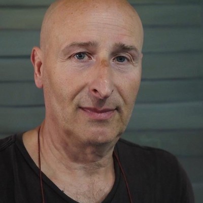 A bald white man wearing a black t-shirt