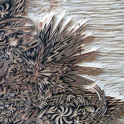 A close-up detail of an intricately carved wood block