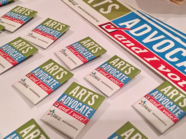 Signage that says "arts advocate, and I vote"