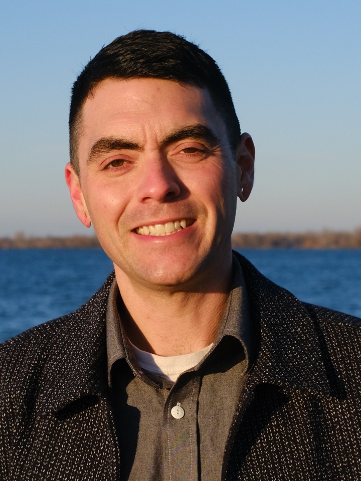 White smiling man with short dark hair
