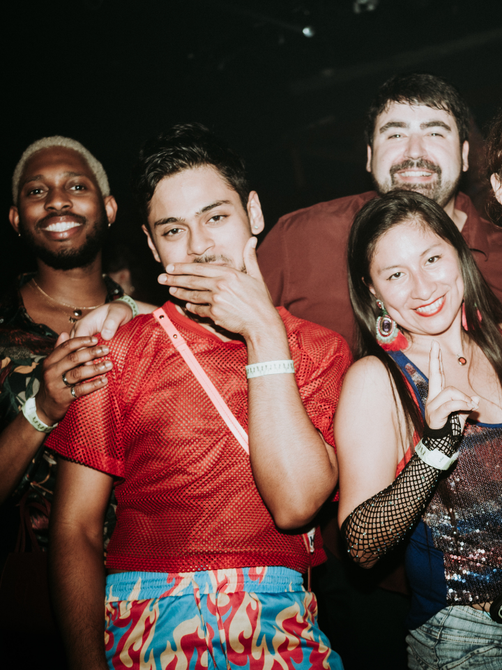A group of people posing for a photo at a party.