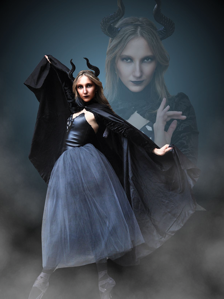 Dramatic photo showing a woman dressed up with dark horns, a dress, and a cape