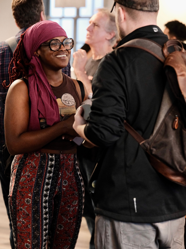 Two people connect in a crowded room
