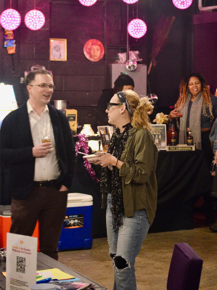 People socializing inside an arts space