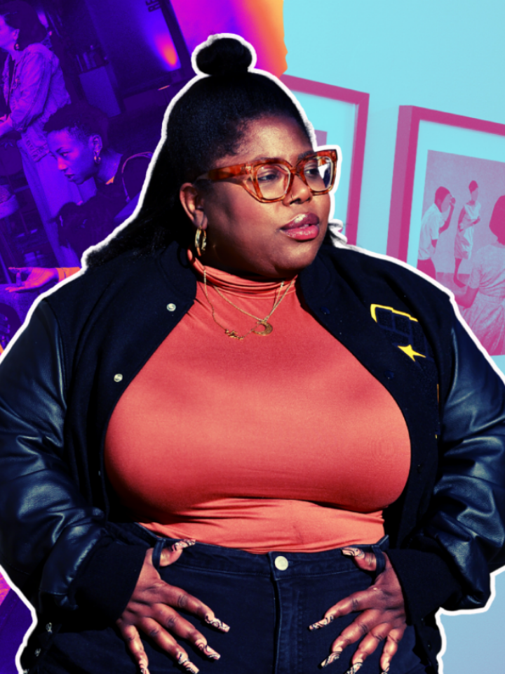 A woman in glasses and a jacket stands confidently against a vibrant background.