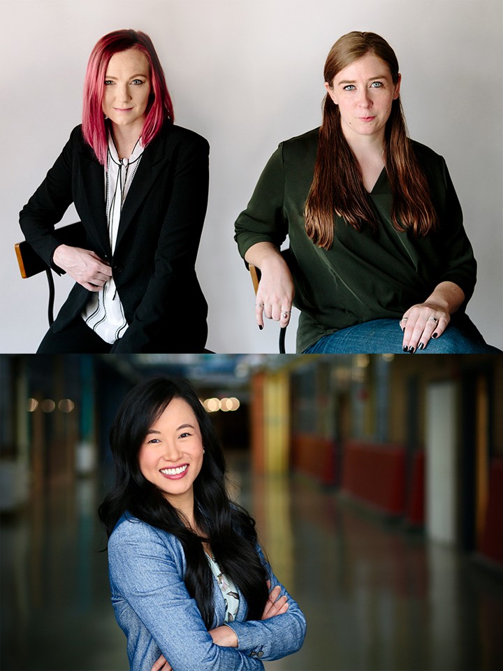 Portraits of three women. At the top, a white woman with shoulder-length straight pink hair, wearing a white button-down shirt and a black blazer, sits in a chair beside a white woman with long straight brown hair, jeans, and a dark green long-sleeved shirt. On the bottom, a smiling Asian woman with long straight black hair and a long-sleeved blue shirt stands with her arms crossed 