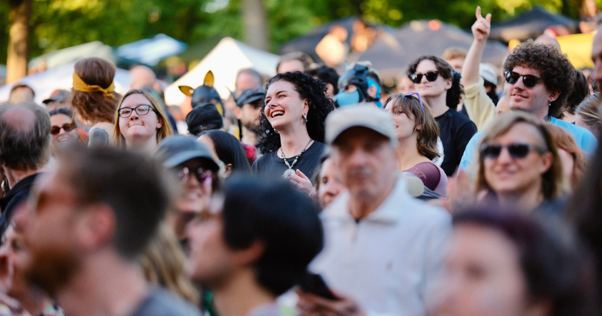 A large crowd gathers at an outdoor venue