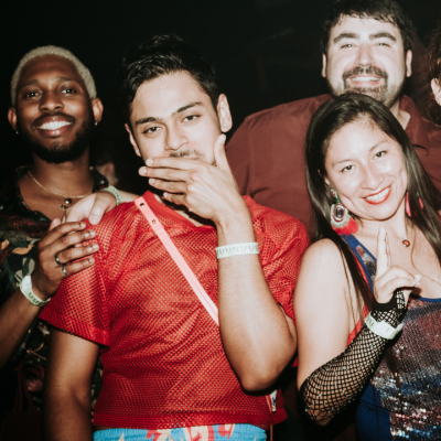 A group of people posing for a photo at a party.