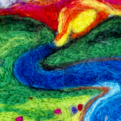 Colorful felt art of a river winding between green hills, with a sunset and clouds above.