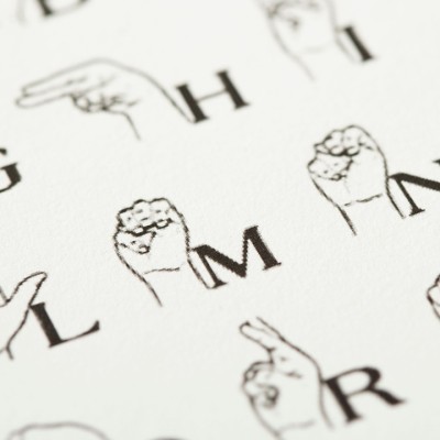 Hands demonstrating various letters in American Sign Language