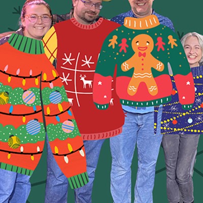 A cropped photo of four smiling people standing in front of a green background. Cartoon holiday sweaters have been Photoshopped on top of them
