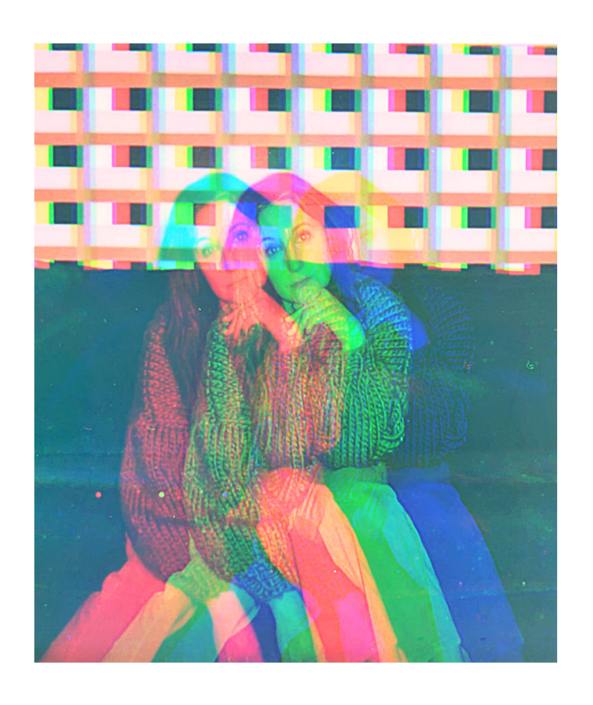 A woman sits against a patterned wall with a colorful, glitch effect overlay.
