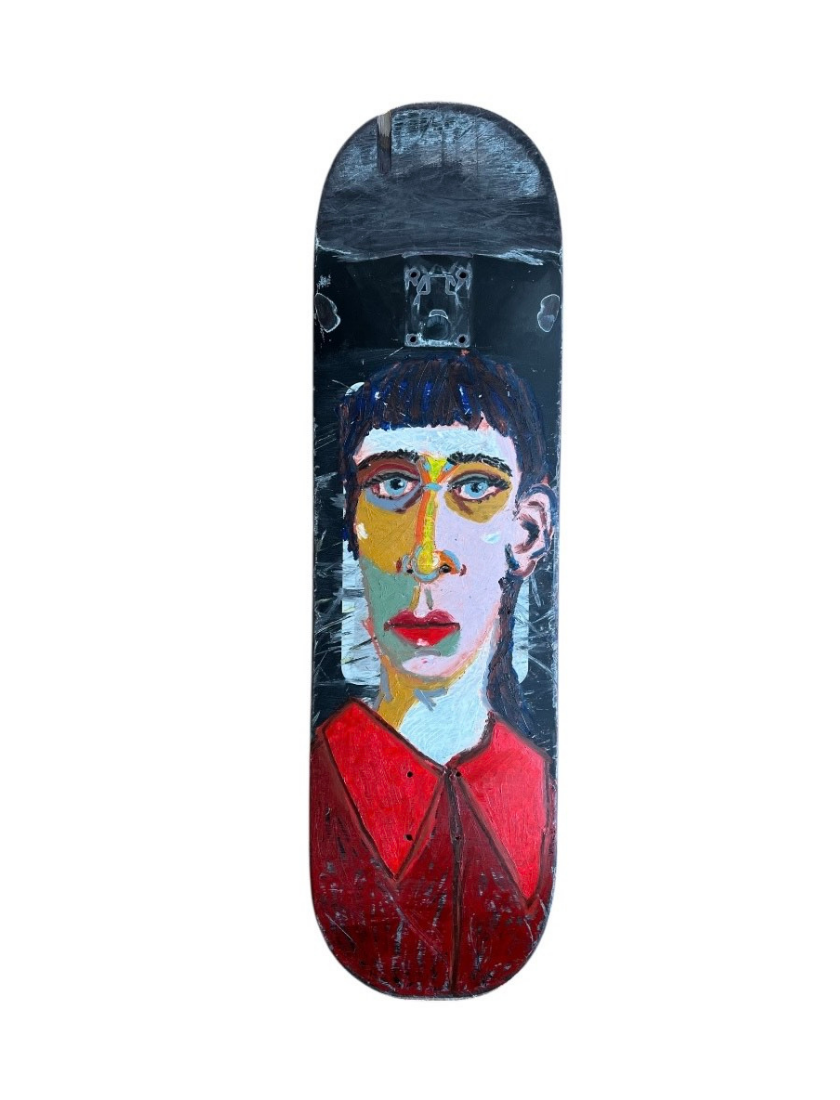 A skateboard deck featuring a colorful, abstract painting of a persons face with blue hair, expressive features, and a red shirt, set against a dark background.