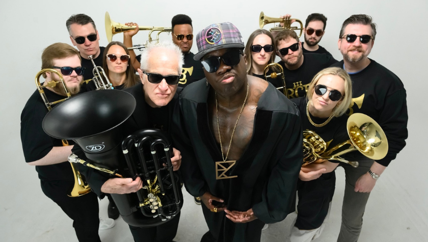 A brass band in sunglasses posing confidently with their instruments against a white background.