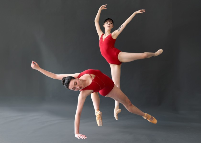 Two ballet dancers in red leotards perform dynamic poses against a gray background.
