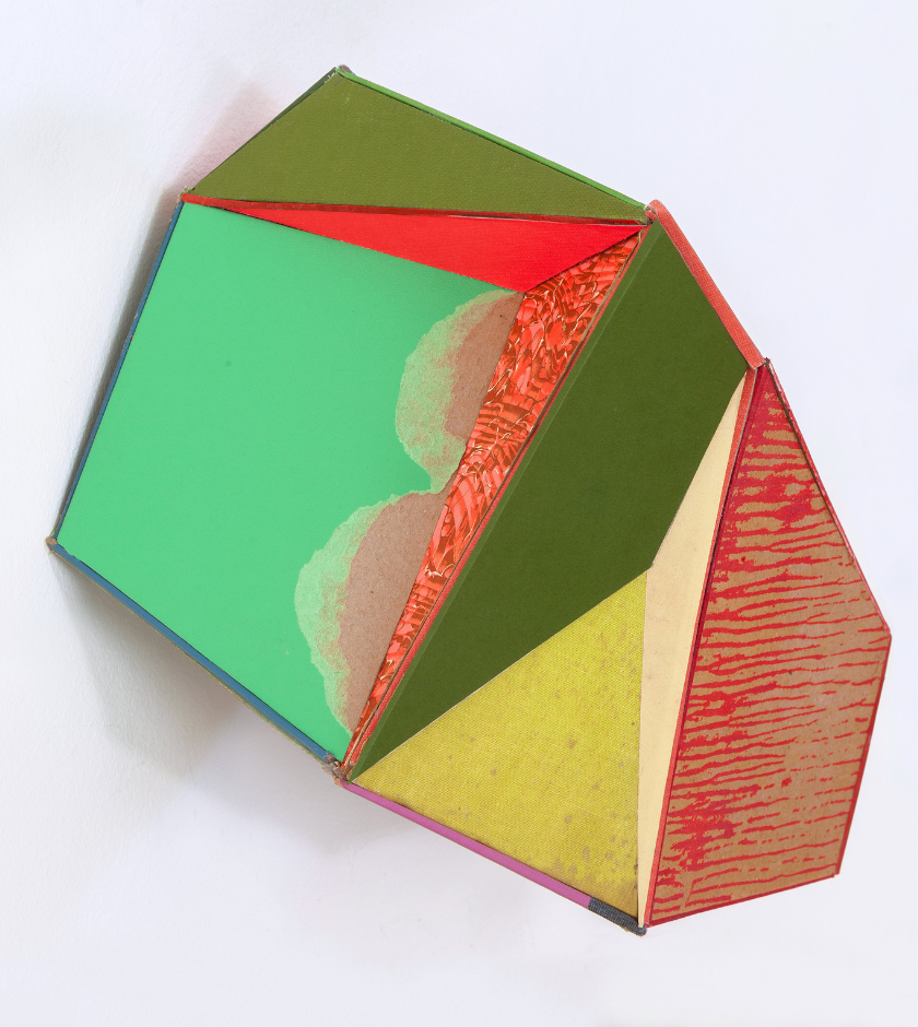 Colorful geometric sculpture with green, yellow, red, and textured triangular faces.