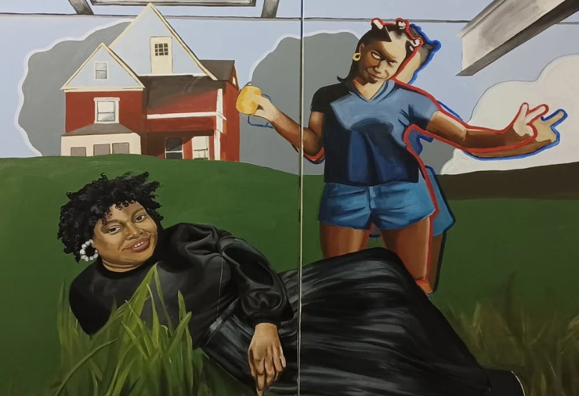 Two women pose on grass; one reclines, one stands, with a red house in the background.