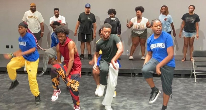 Young Black dancers perform in a rehearsal space
