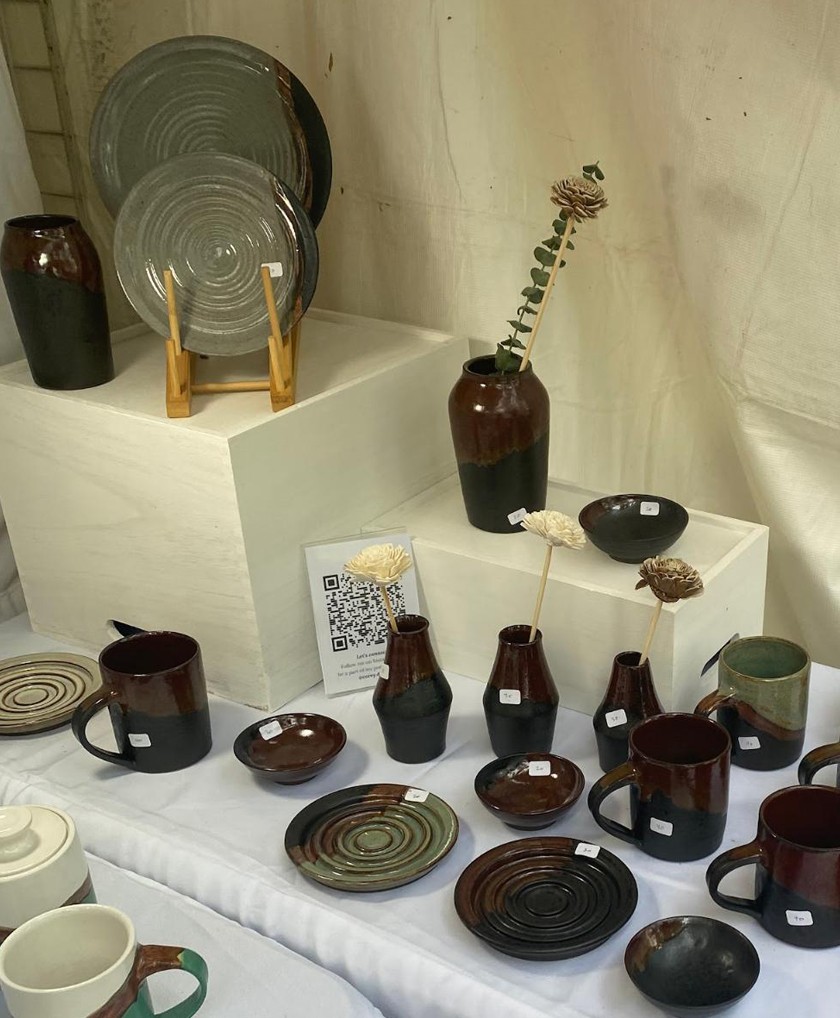 Handmade pottery displayed in an artistic booth