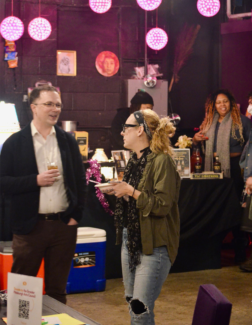 People socialize inside an arts space