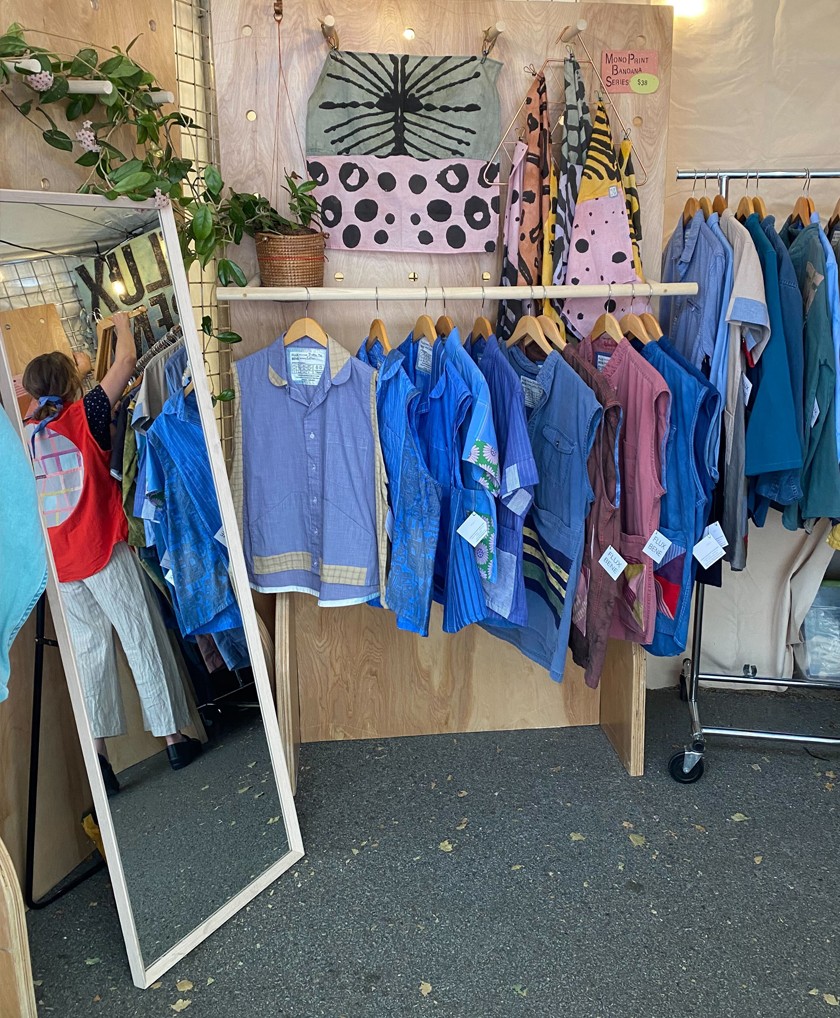 A display of upcycled clothing inside a booth