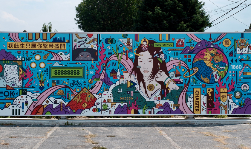 Colorful mural of a woman surrounded by abstract shapes, symbols, and vibrant patterns outdoors.
