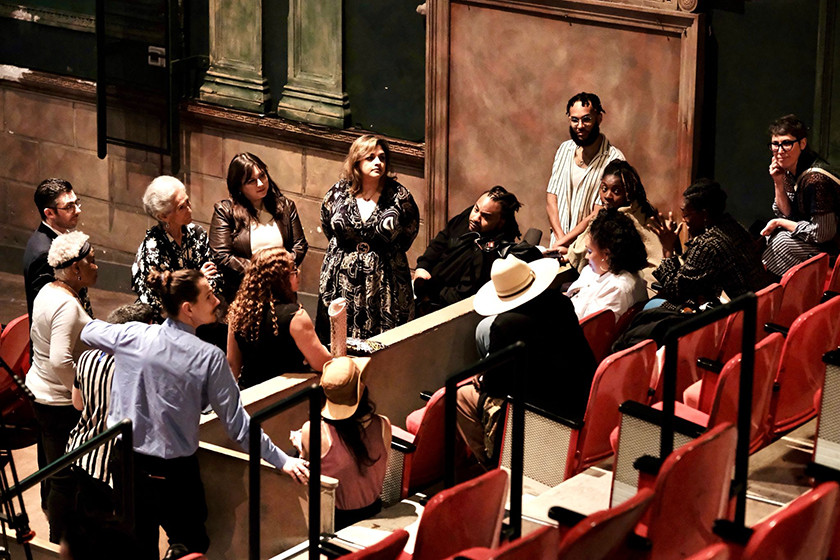 A group of people gather in a circle, engaged in conversation