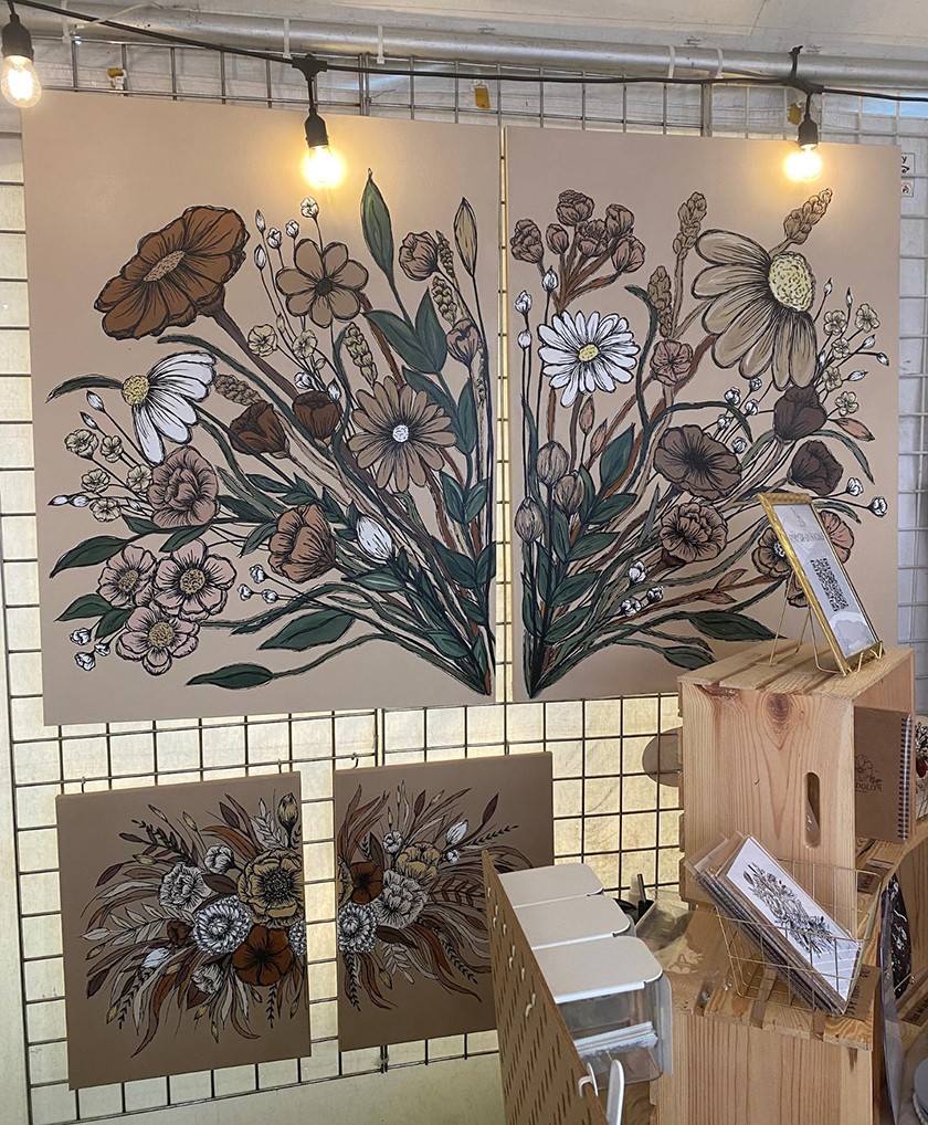 Artwork of acrylic painted flowers displayed in a booth at the Arts Festival