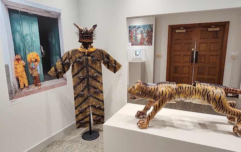 A museum display of various Mexican masks representing jaguars