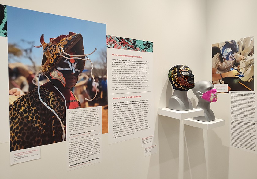 A museum display showing Indigenous Mexican masks with descriptions and Mexican “Lucha Libre” wrestling masks
