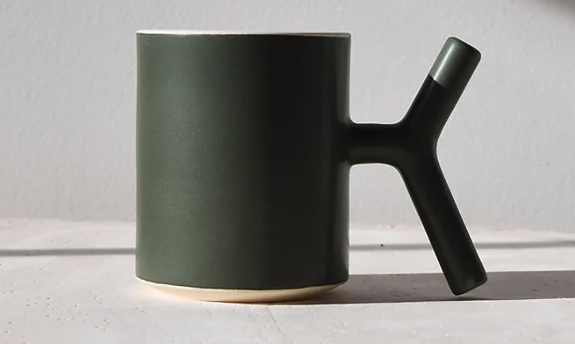Green mug featuring a K-shaped handle