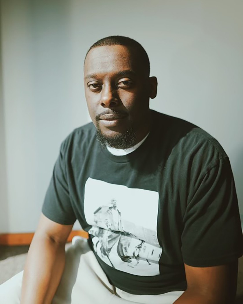 Portrait of Black man with short cropped dark hair and a goatee