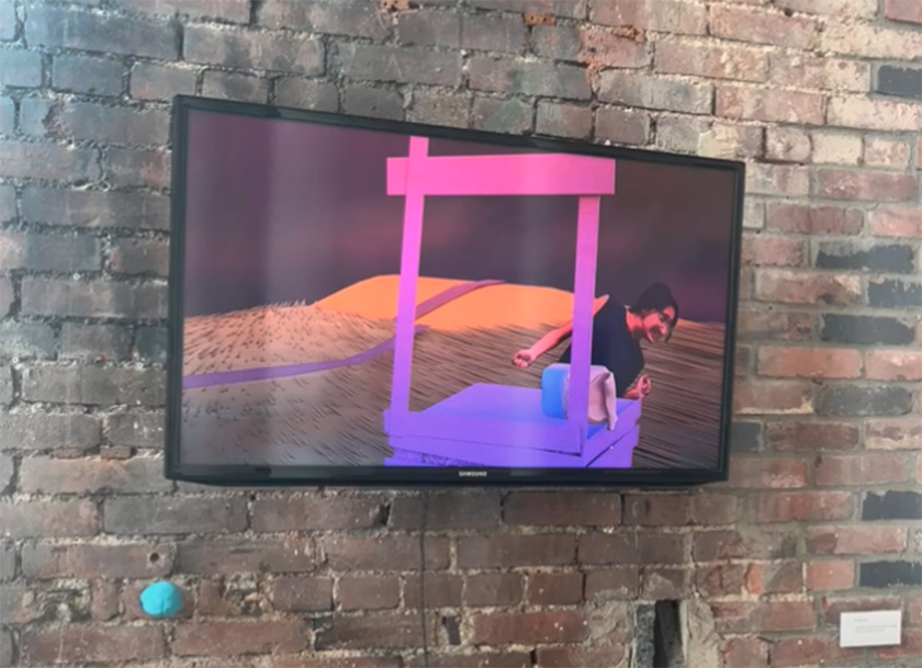 A TV mounted on a brick wall displays animated art of a person leaning over a purple well-like structure with hills and a dark sky in the background.